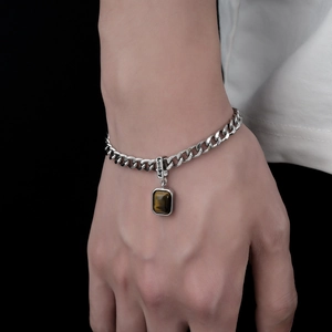 Silver cuban chain bracelet with tiger eye stone pendant and lucky charm engraving
