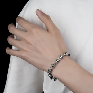 Detailed close-up of titanium steel knot bracelet showing unique ring and ball link design