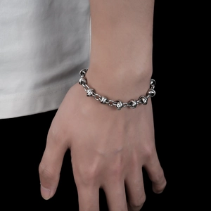 Titanium steel chain bracelet with unique knot links shown on wrist for men and women