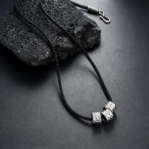 Silver textured cylinder bead pendant on black woven cord necklace for men and women