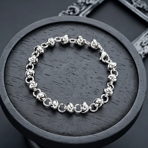 Close-up of industrial knot links and lobster clasp on silver titanium steel bracelet