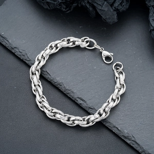 Mens silver titanium steel braided chain bracelet with lobster clasp on rock background