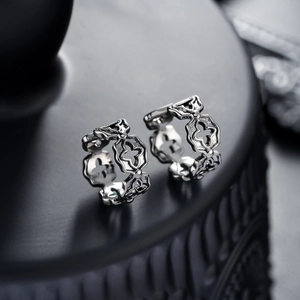 Gothic hollow cross ear clips in polished silver finish for a trendy unisex punk aesthetic