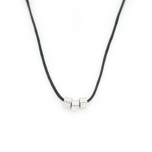 Minimalist silver cylinder beads on black braided rope necklace shown on white background