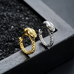 Macro view of gold and silver snake earrings featuring detailed textured scales
