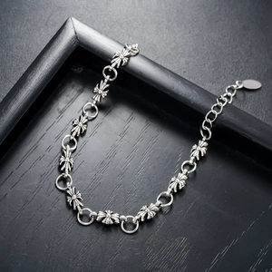 Detail of vintage silver cross link bracelet with adjustable chain on black wood