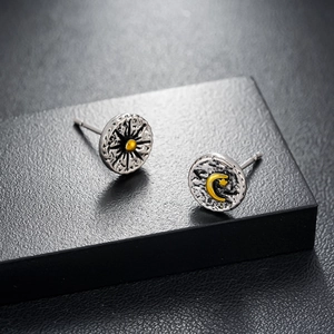 Retro asymmetric sun and moon stud earrings in vintage silver with gold accents