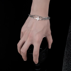 Double-layered silver star bracelet with zircon pendant on a fashion model's hand
