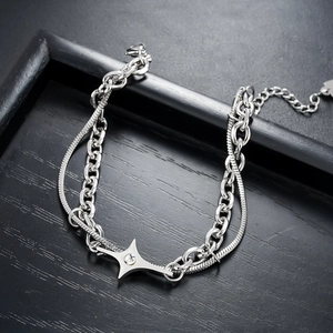 Detail of silver double-layer bracelet with star pendant and sleek snake chain link