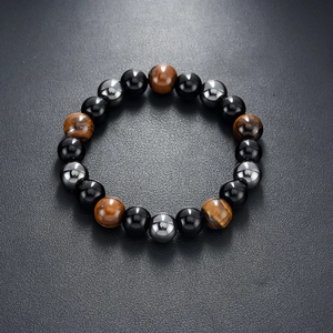 Detailed view of obsidian, tiger eye, and hematite stone beads on a dark leather surface