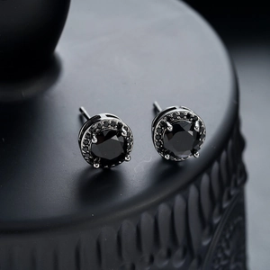 Detailed view of men's black rhinestone stud earring with a dark faceted centerpiece