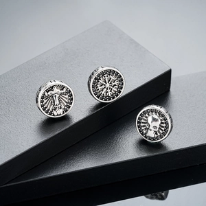 Vintage silver magnetic ear clips with skull, compass, and cross patterns set in black stone