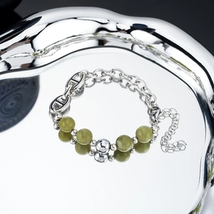 Detail of hip-hop retro bracelet with green natural stone beads and silver pig nose chain