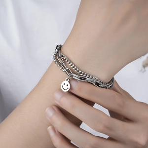 Men's layered stainless steel bracelet with Cuban link and smiley face charm