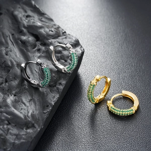 Chic silver and gold huggie earrings with emerald green pavé zircons on dark stone