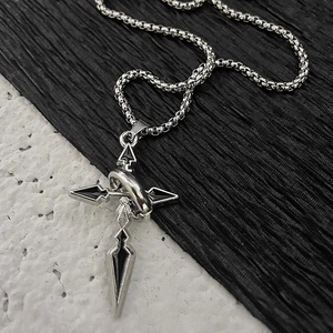 Detail of gothic titanium steel cross pendant with black enamel on stone texture background