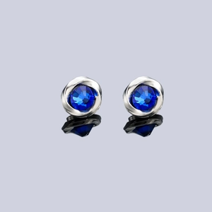Macro detail of Mobius blue zircon magnetic earrings with polished silver finish