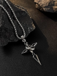 Detailed close-up of a titanium cross pendant with black enamel on a silver box chain