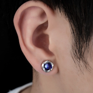 Close-up of Mobius magnetic ear clip with deep blue zircon and silver swirl metal base