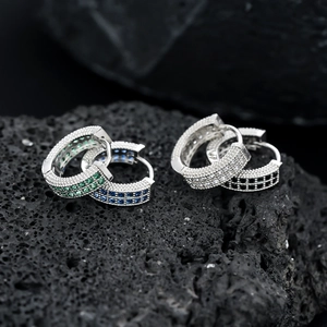 Detail of four pairs of hip hop hoop earrings with micro-pave crystals on lava stone