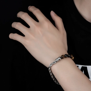 Men's tiger eye stone bead and stainless steel twist chain bracelet on male wrist
