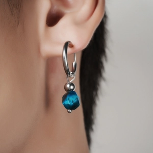 Vue rapprochée d'une boucle d'oreille en argent avec perle bleue en œil-de-chat