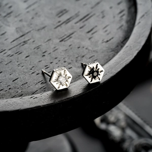 Vintage hexagonal sunburst stud earrings in silver metal with black and white zircon