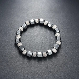 Detailed view of industrial style dark gray hematite beads and textured silver balls