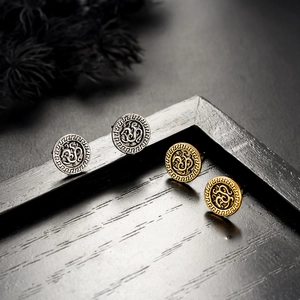 Vintage round stud earrings in silver and gold with intricate Greek meander engravings