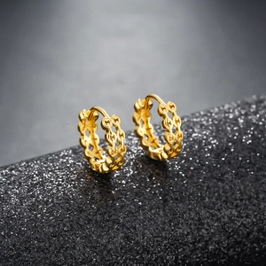 Retro golden hoop earrings with woven chain link texture in a minimalist polished finish