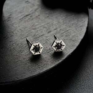 Macro shot of silver hexagon earring with black center stone and SINCE engraving