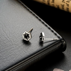 Close-up of hexagonal sunburst studs with black zircon inlay and vintage steel finish