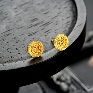 Vintage gold round stud earrings featuring classic Greek key pattern and embossed center