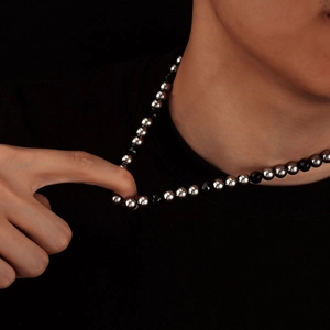 Modern geometric necklace with black faceted beads and silver titanium steel beads