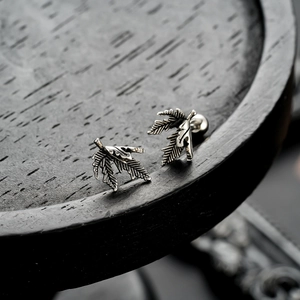 Vintage silver maple leaf stud earrings with detailed vein engraving and screw back closure