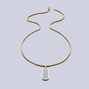 Macro detail of gold-plated box chain and rectangular geometric pendant with grey inlay