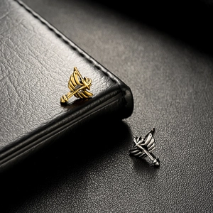Unisex angel wing stud earrings with sword detail in gold and silver finish