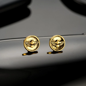 Luxury eagle embossed gold stud earrings with detailed feathers and brushed metal finish