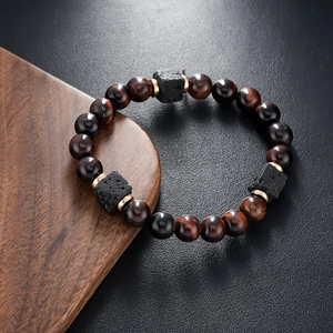 Macro shot of brown tiger eye beads and black lava stones on a vintage men's bracelet