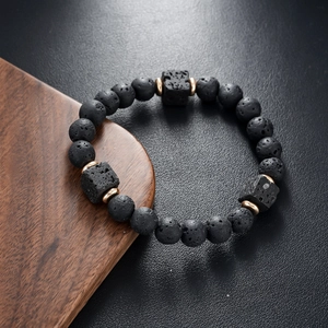Macro shot of lava stone beads and cubic accents with textured volcanic pores on the bracelet