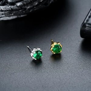 Classic four-prong green zircon stud earrings in silver and gold metal settings