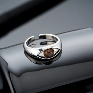Detailed macro of vintage silver Eye of Horus ring with brown tiger eye stone setting
