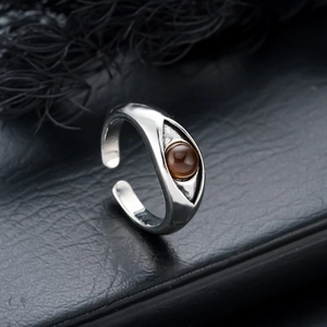 Macro view of vintage silver Eye of Horus ring with a polished brown gemstone inlay