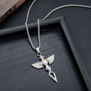 Macro shot of silver cross pendant with iridescent gemstone on dark wood background