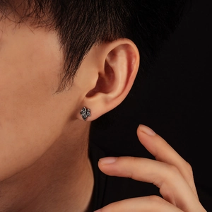 Retro maple leaf stud earring in vintage silver finish on model for men and women