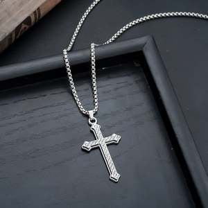 Detail of silver cross pendant with pavé set cubic zirconia on a box chain necklaces