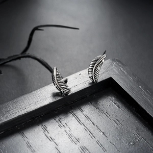 Vintage feather stud earrings in retro silver steel finish with detailed texture design