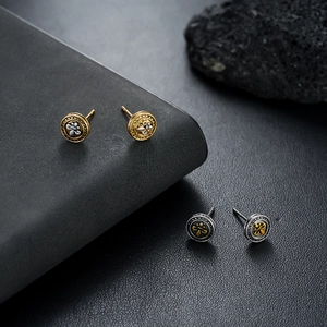 Vintage round fleur-de-lis stud earrings in embossed gold and silver metal finish