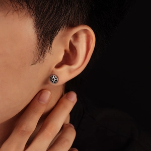 Vintage sun totem stud earring in oxidized silver finish worn on model's ear