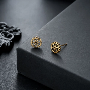 Detailed close-up of retro gear-shaped studs with a vintage gold industrial steampunk finish